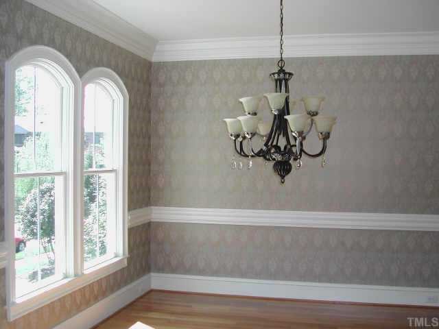 7830 Monument Lane Raleigh, NC 27615 - Photo 5 of 10 Formal Dining Room features Custom Windows, Elegant Chandelier and Wallpaper