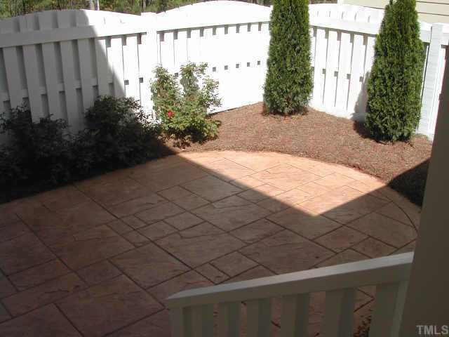 7830 Monument Lane Raleigh, NC 27615 - Photo 7 of 10 Private Courtyard features Fencing, Plant Material and Textured Concrete Floor