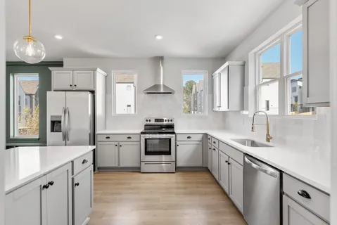 a kitchen with a sink stove and refrigerator