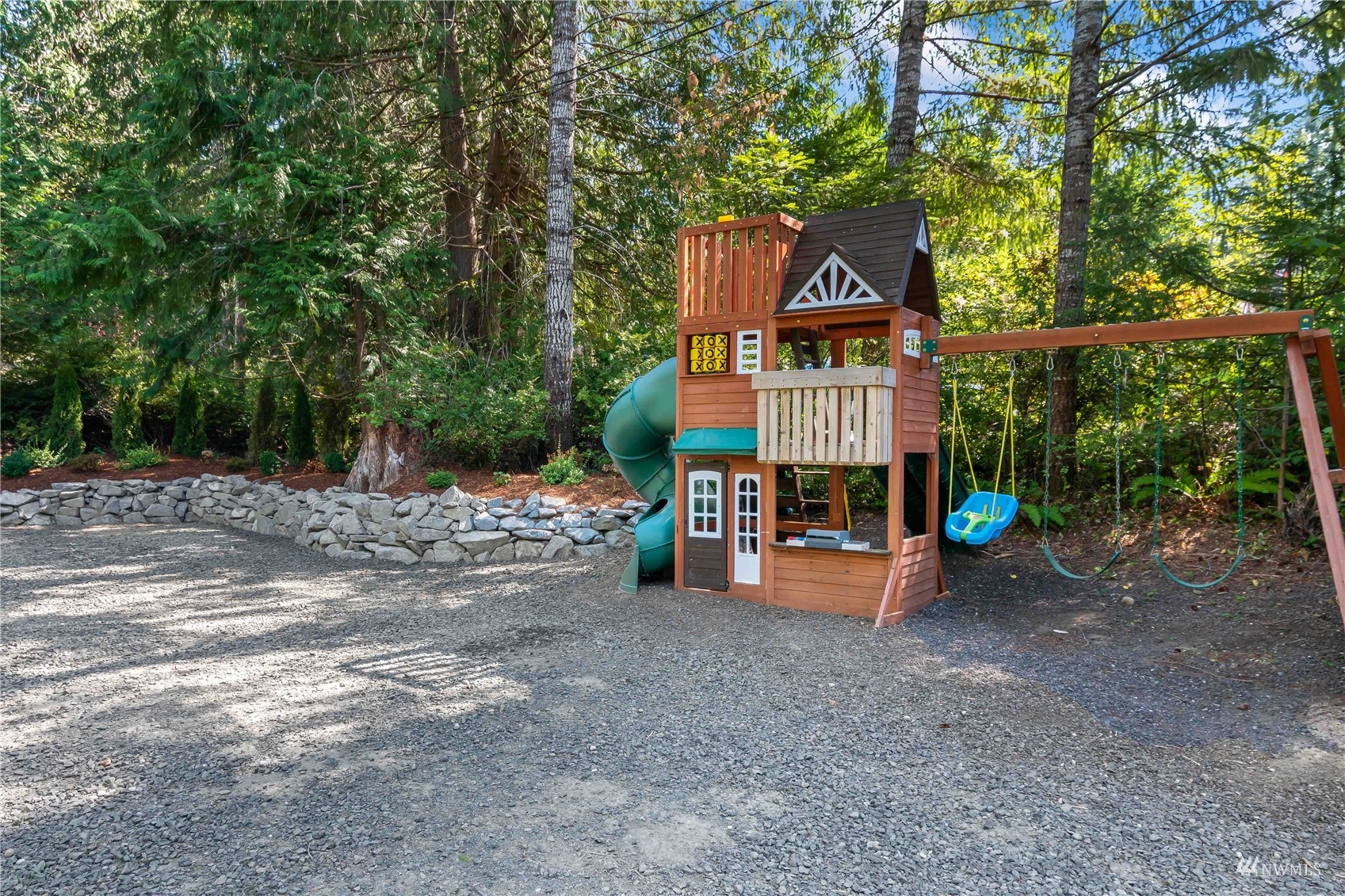 51 East Canyon View Road Belfair, WA 98528 - Photo 22 of 35 a view of a street with potted plants and large trees