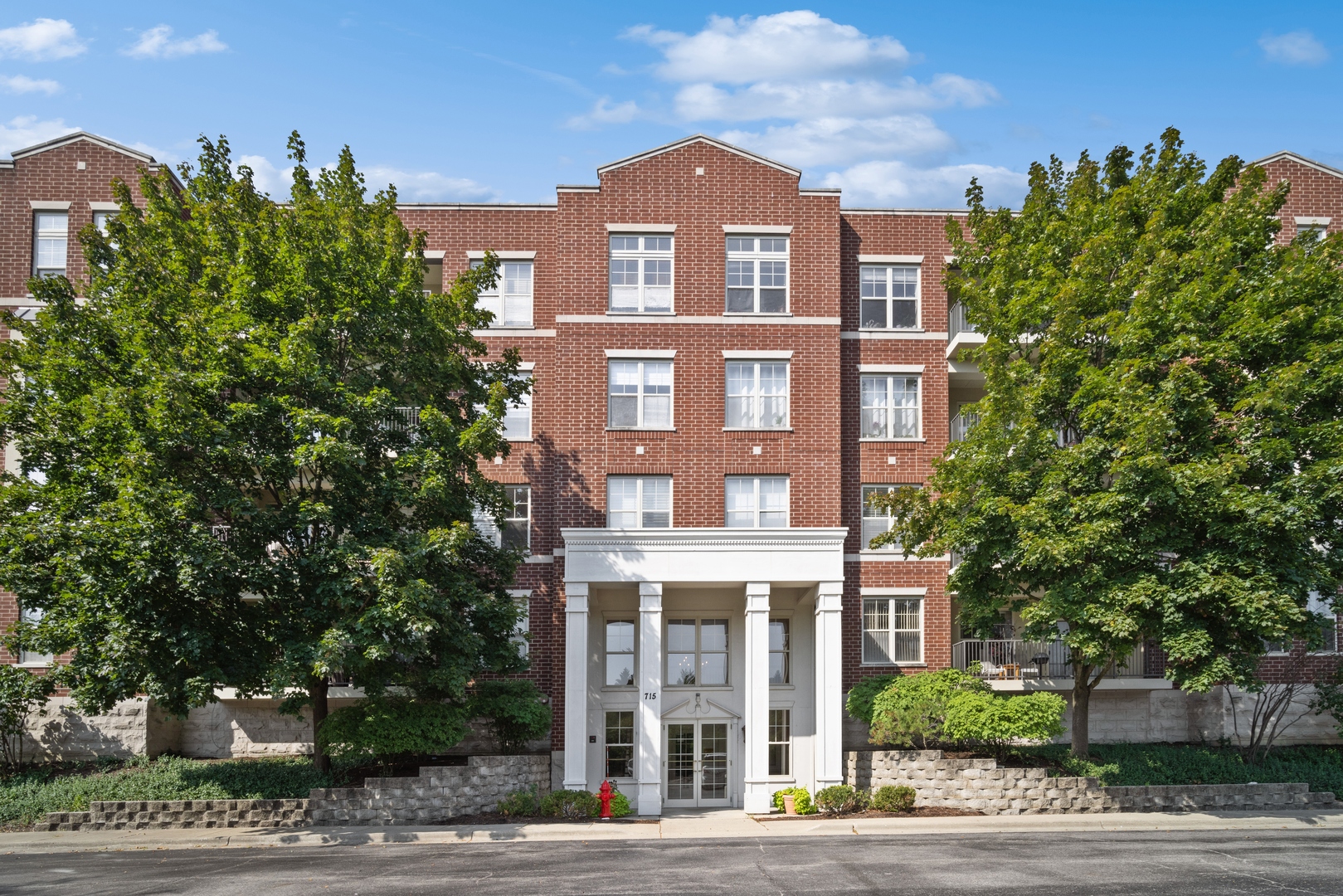 715 Astor Lane, Unit 402 Wheeling, IL 60090 - Photo 1 of 12 a front view of a building