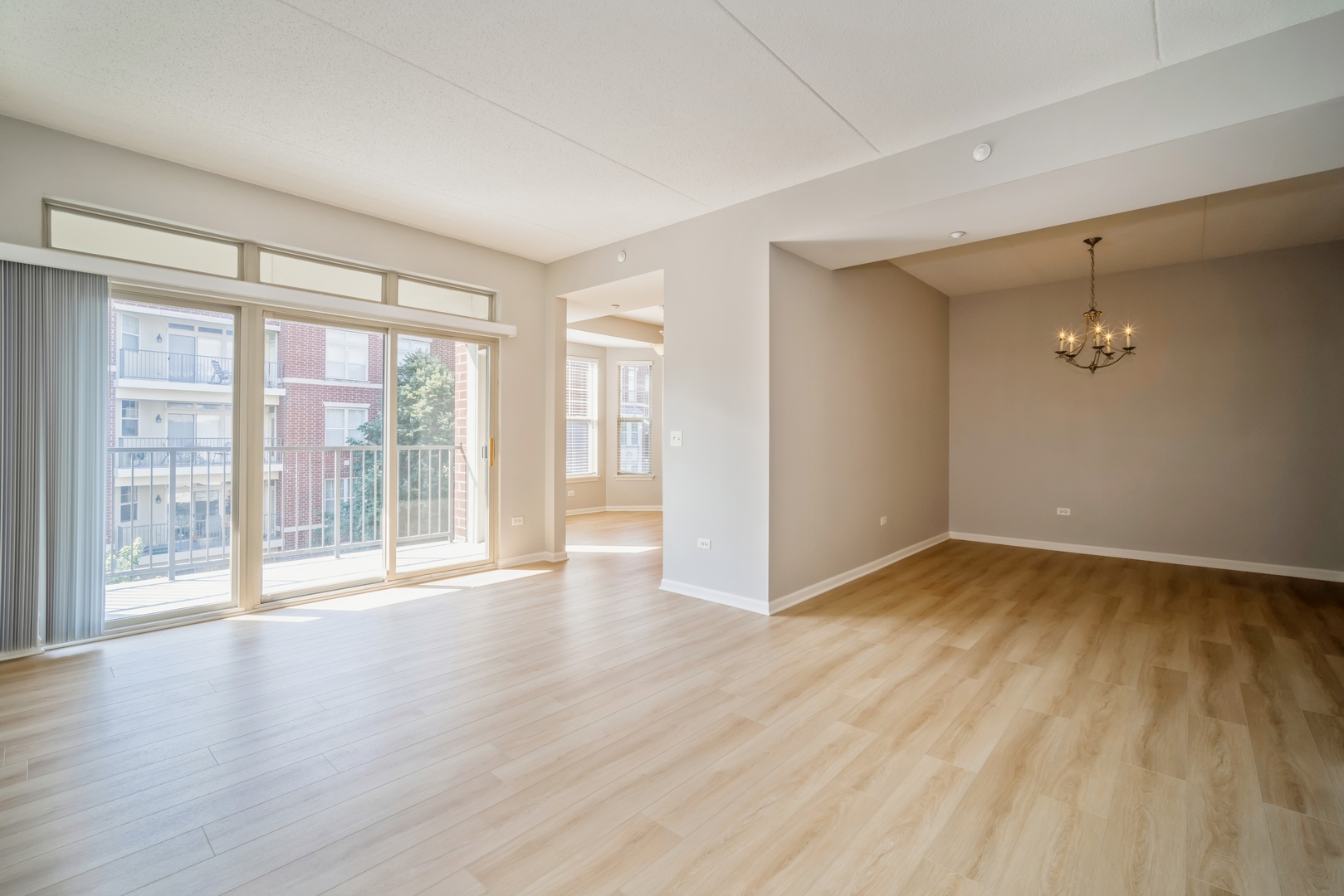 715 Astor Lane, Unit 402 Wheeling, IL 60090 - Photo 2 of 12 a view of an empty room with wooden floor and a window