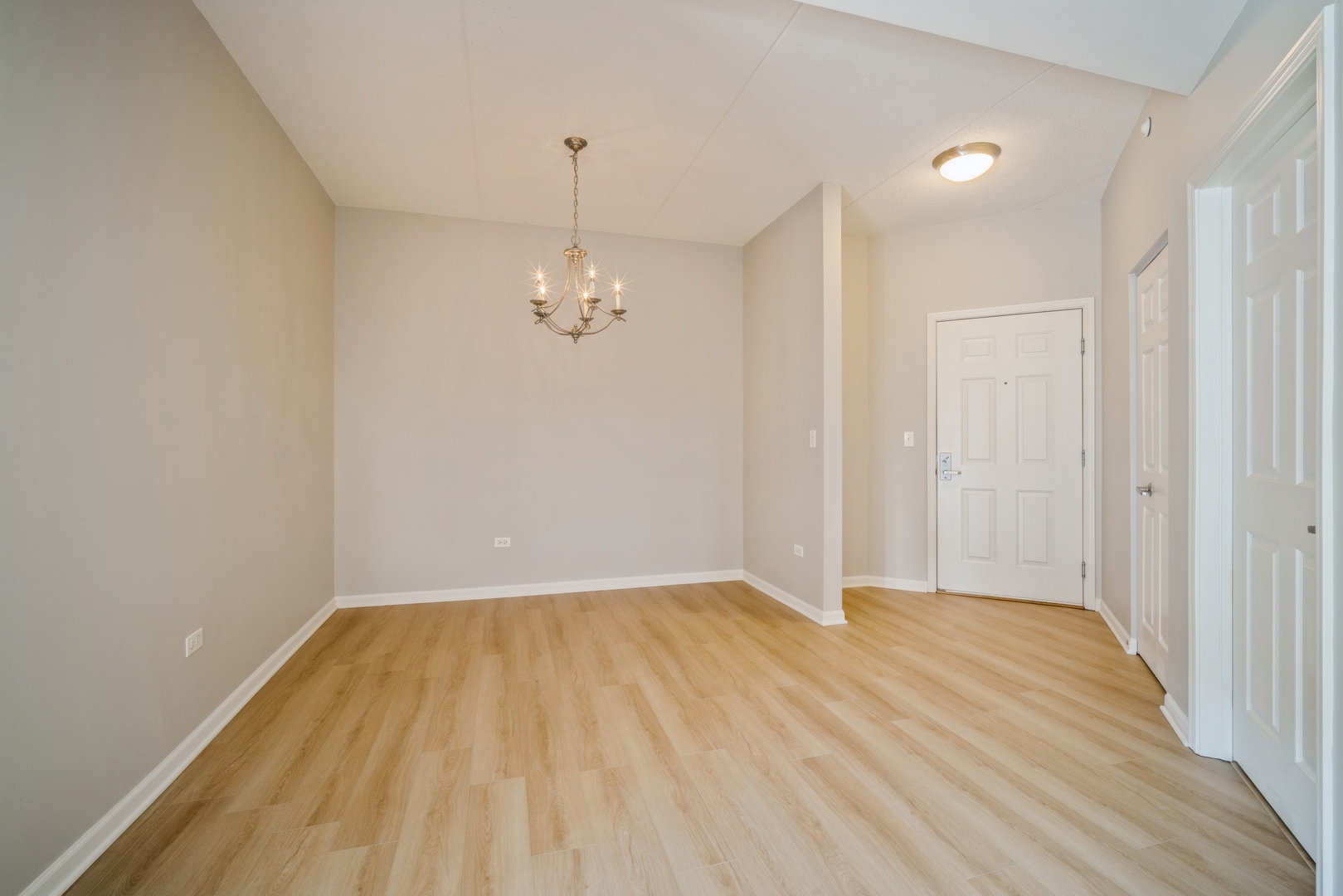715 Astor Lane, Unit 402 Wheeling, IL 60090 - Photo 3 of 12 a view of empty room with wooden floor