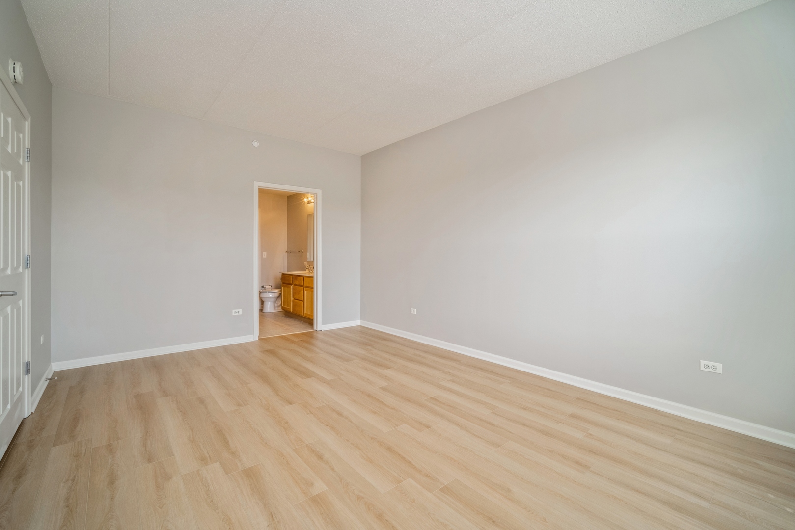 715 Astor Lane, Unit 402 Wheeling, IL 60090 - Photo 6 of 12 a view of an empty room with wooden floor and a window
