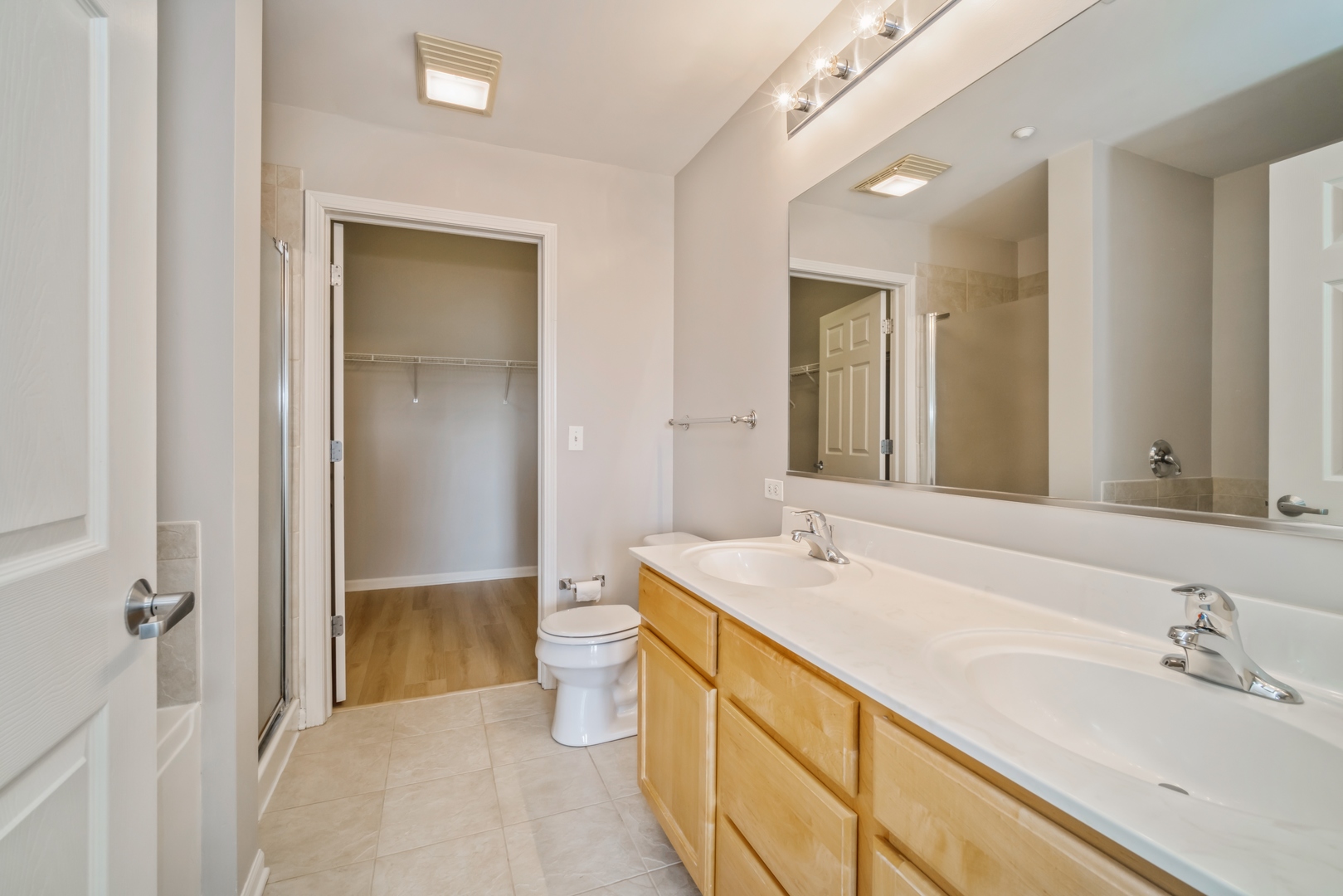 715 Astor Lane, Unit 402 Wheeling, IL 60090 - Photo 7 of 12 a bathroom with a sink and a mirror