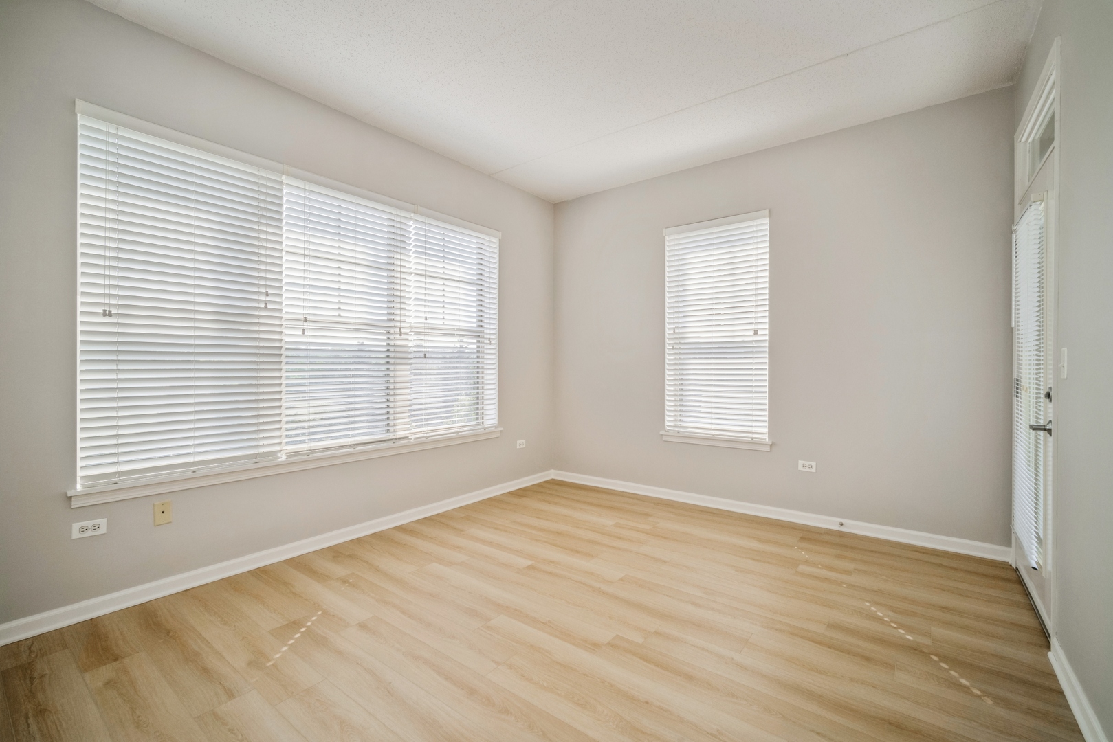715 Astor Lane, Unit 402 Wheeling, IL 60090 - Photo 9 of 12 a view of an empty room with wooden floor and a window