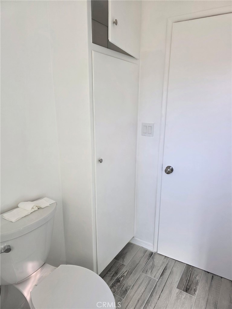 928 West Angeleno Avenue, Unit C Burbank, CA 91506 - Photo 13 of 14 a bathroom with a granite countertop toilet and a shower