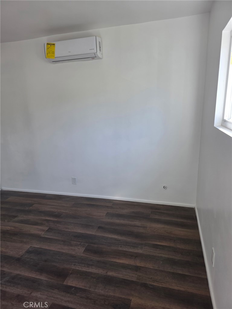 928 West Angeleno Avenue, Unit C Burbank, CA 91506 - Photo 2 of 14 a view of an empty room with wooden floor and a window