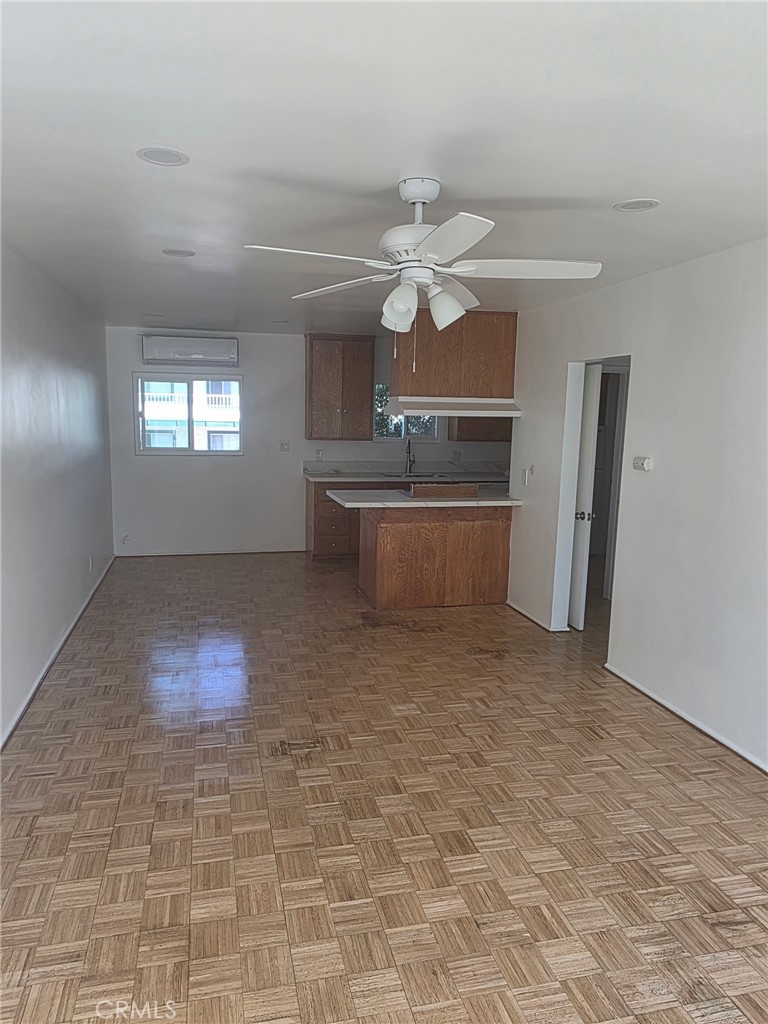 928 West Angeleno Avenue, Unit C Burbank, CA 91506 - Photo 3 of 14 en empty room with windows and ceiling fan