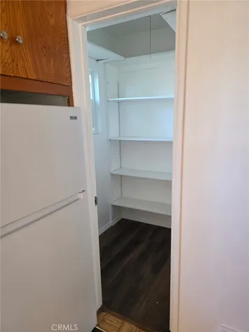 a view of walk in closet with empty racks
