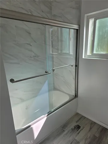 a bathroom with a glass shower door
