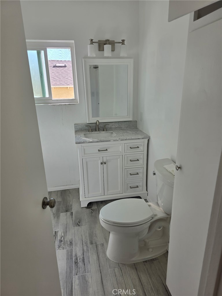 928 West Angeleno Avenue, Unit C Burbank, CA 91506 - Photo 10 of 14 a bathroom with a toilet sink and mirror