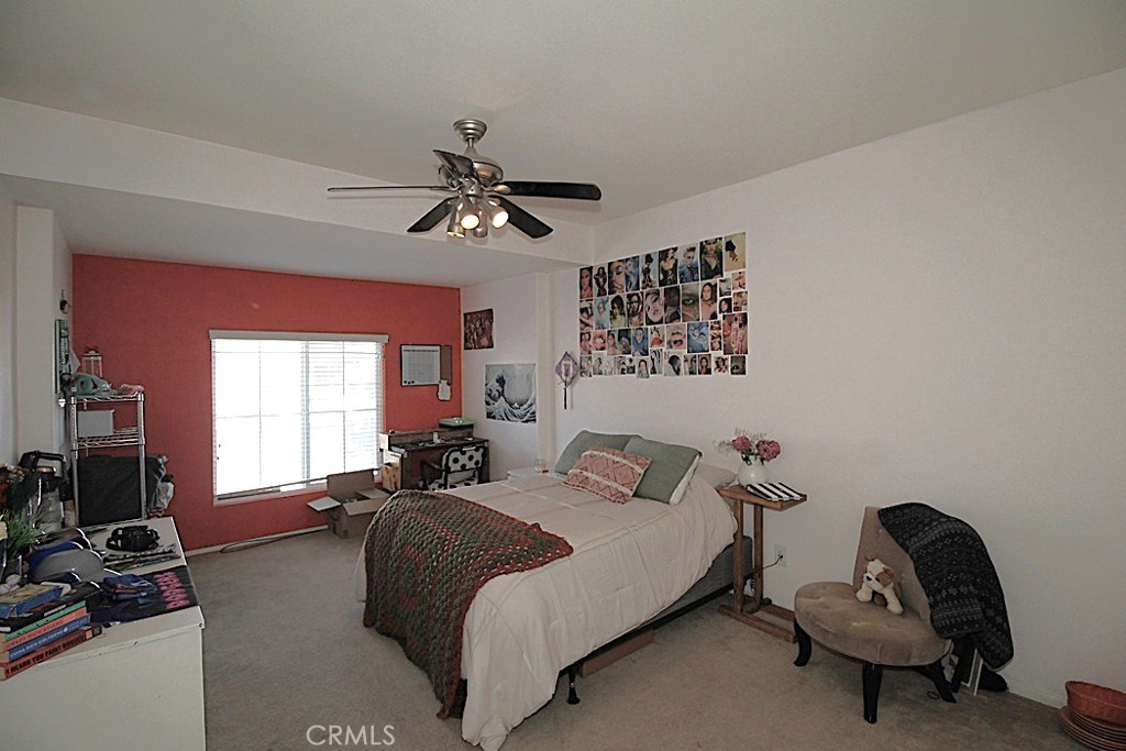 924 Condor Street Barstow, CA 92311 - Photo 18 of 52 a bedroom with a bed a couch and a window