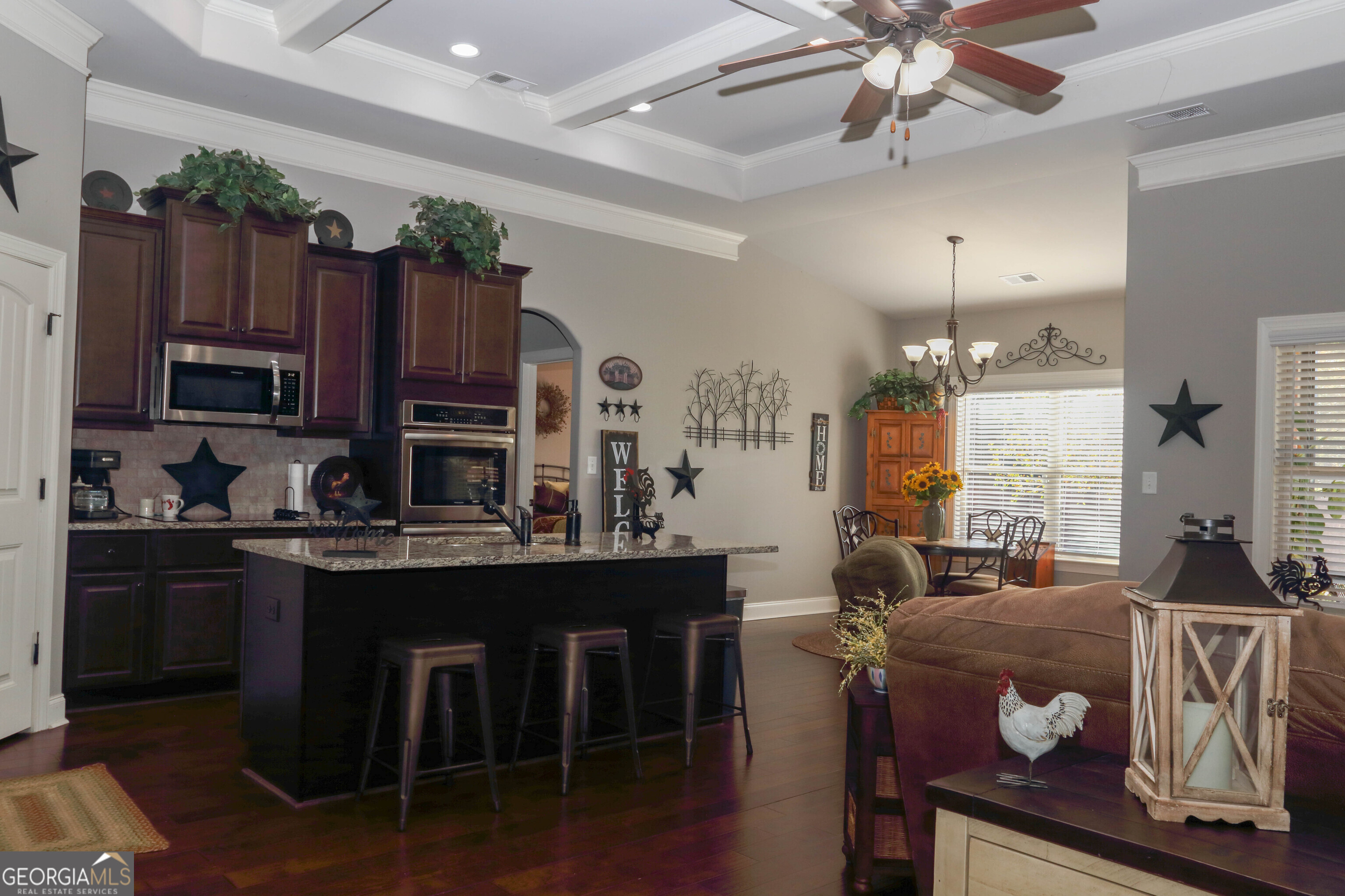 107 Westchester Trail Kathleen, GA 31047 - Photo 5 of 36 a kitchen with kitchen island a stove a sink a dining table and chairs