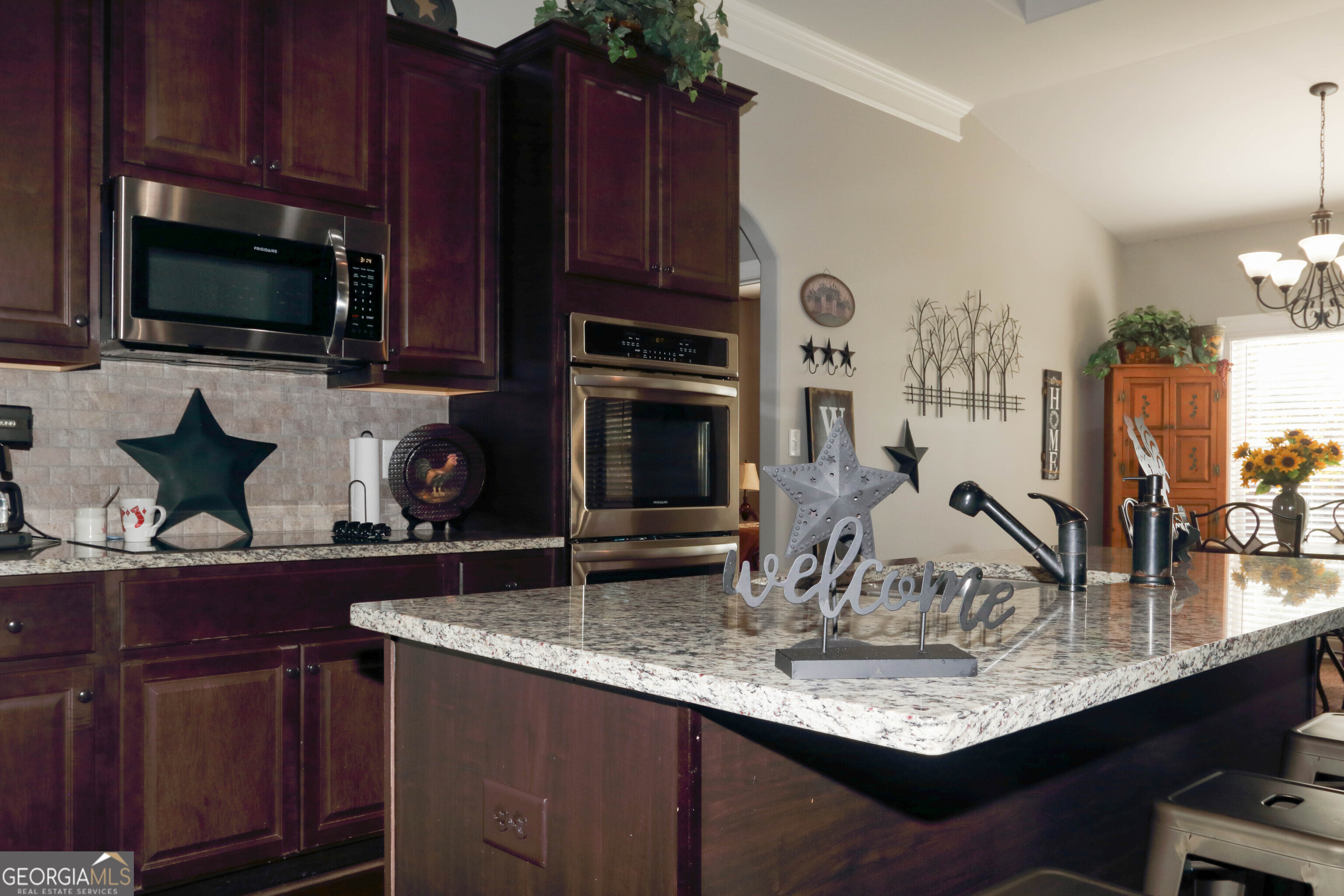 107 Westchester Trail Kathleen, GA 31047 - Photo 6 of 36 a kitchen with kitchen island granite countertop a sink stainless steel appliances and cabinets