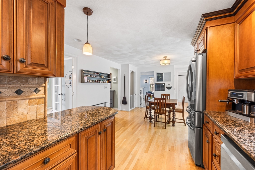 40 Station Road Salem, MA 01970 - Photo 11 of 36 a kitchen with stainless steel appliances granite countertop sink stove top oven and cabinets