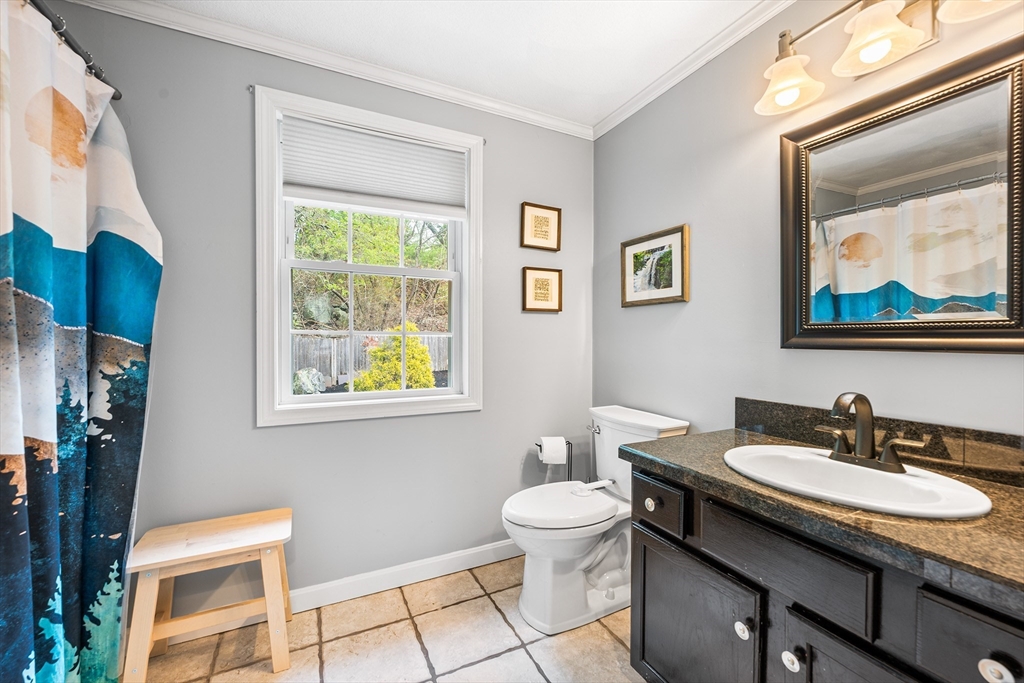 40 Station Road Salem, MA 01970 - Photo 25 of 36 a bathroom with a toilet a sink a mirror and a window