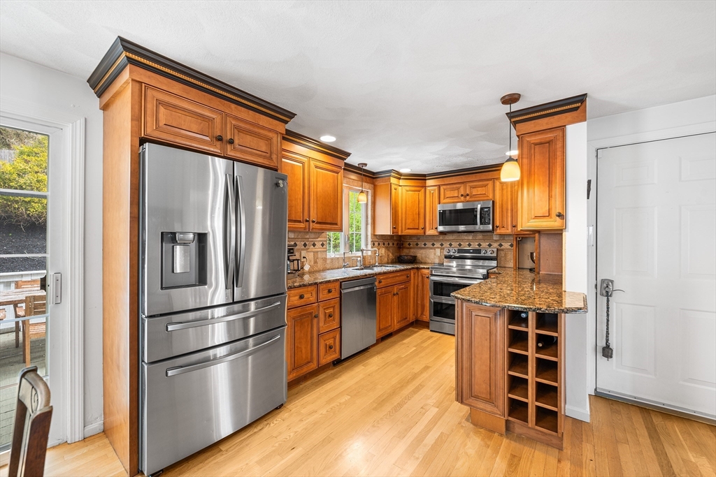 40 Station Road Salem, MA 01970 - Photo 7 of 36 a kitchen with stainless steel appliances granite countertop a refrigerator and a stove top oven