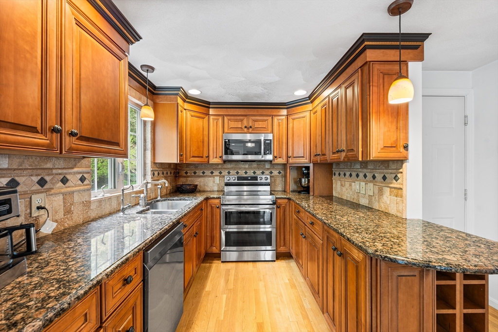 40 Station Road Salem, MA 01970 - Photo 9 of 36 a kitchen with stainless steel appliances granite countertop a stove a sink and a microwave