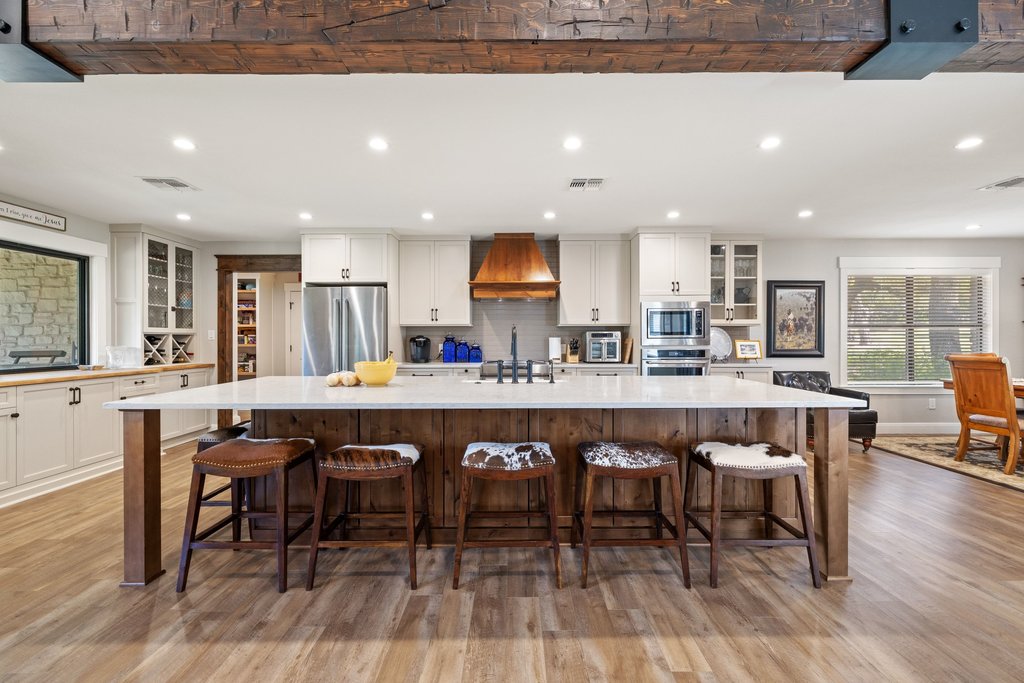 23644 Nameless Road Leander, TX 78641 - Photo 5 of 40 A spacious kitchen with rustic wooden beams overhead and a large island, perfect for entertaining.