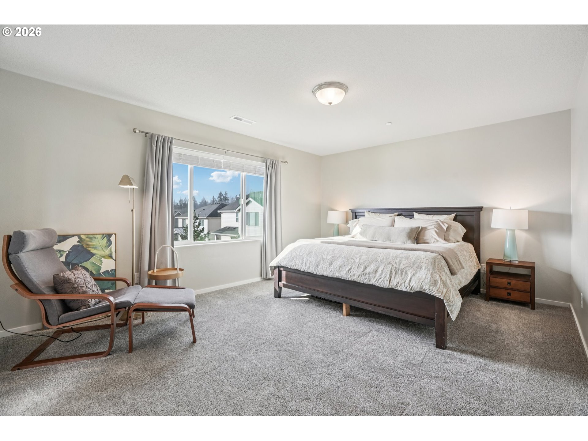 1712 Northeast Pioneer Lane Camas, WA 98607 - Photo 13 of 25 a bedroom with a bed a chair and painting on the wall