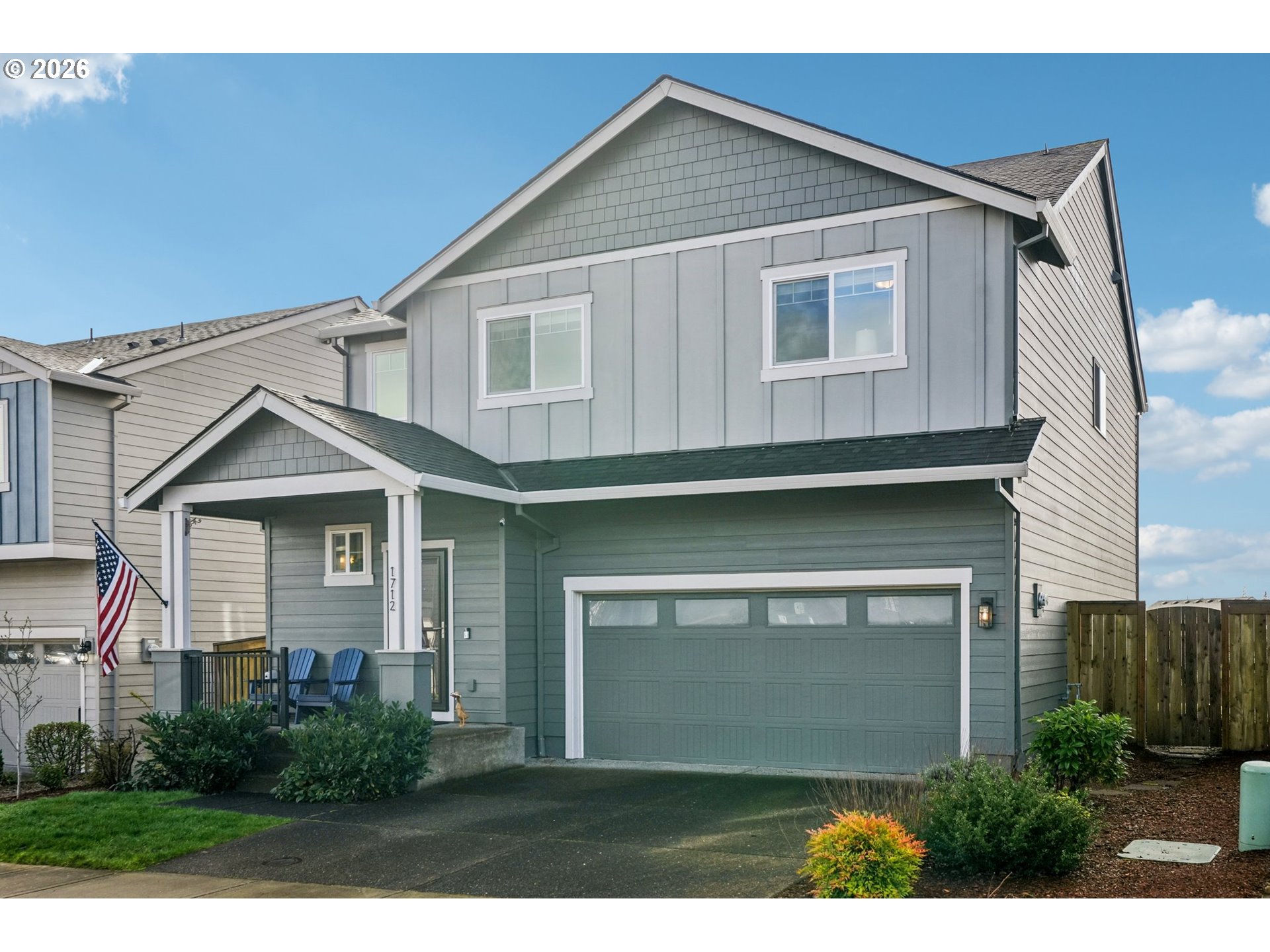 1712 Northeast Pioneer Lane Camas, WA 98607 - Photo 2 of 25 a front view of a house with a garden and garage