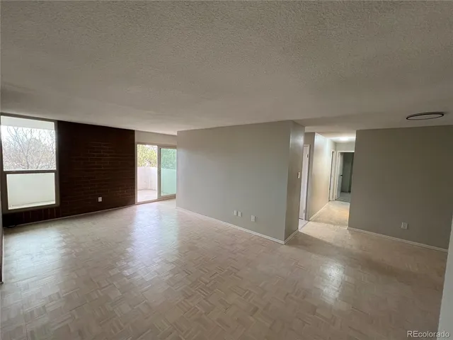 a kitchen with granite countertop a refrigerator and a stove top oven