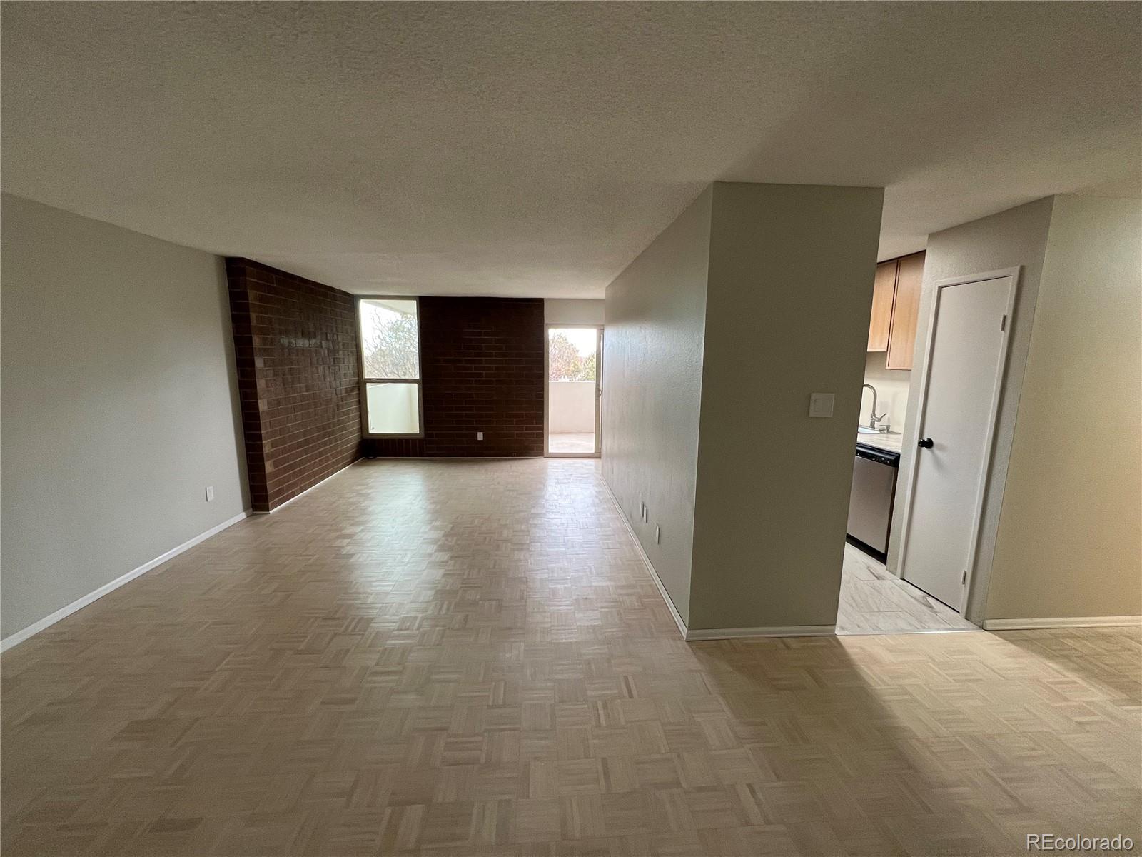 2880 South Locust Street, Unit 507S Denver, CO 80222 - Photo 14 of 48 a view of a livingroom with wooden floor and closet