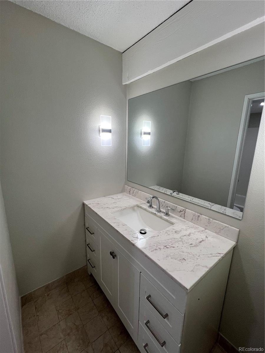 2880 South Locust Street, Unit 507S Denver, CO 80222 - Photo 18 of 48 a bathroom with a sink and vanity