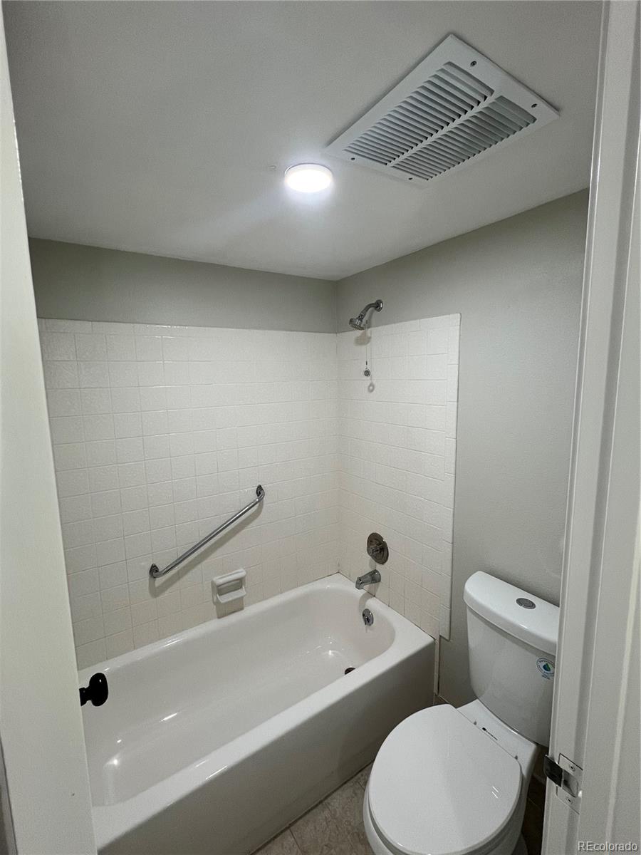 2880 South Locust Street, Unit 507S Denver, CO 80222 - Photo 21 of 48 a bathroom with a toilet a sink and bathtub