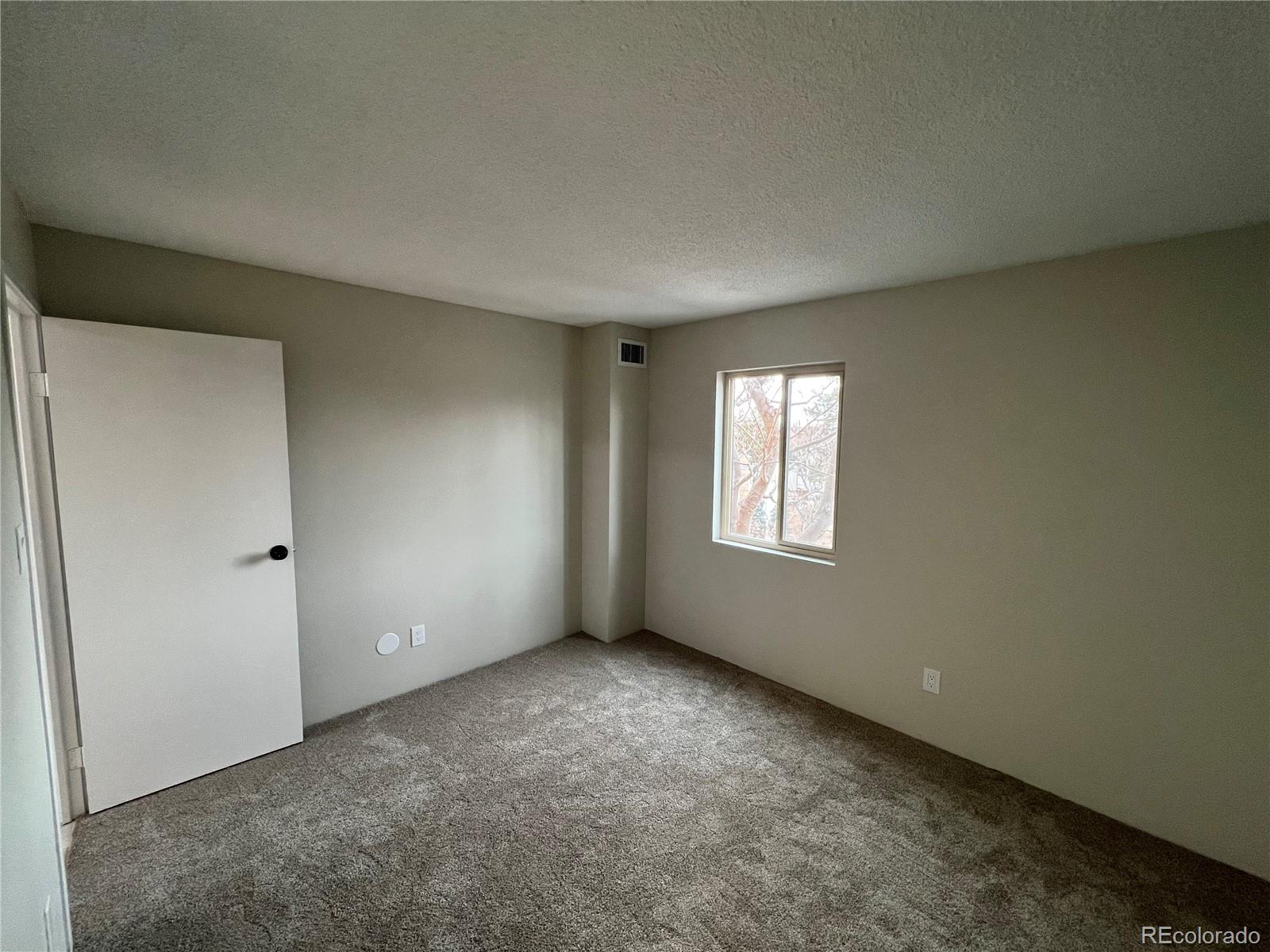 2880 South Locust Street, Unit 507S Denver, CO 80222 - Photo 30 of 48 a view of an empty room with a window