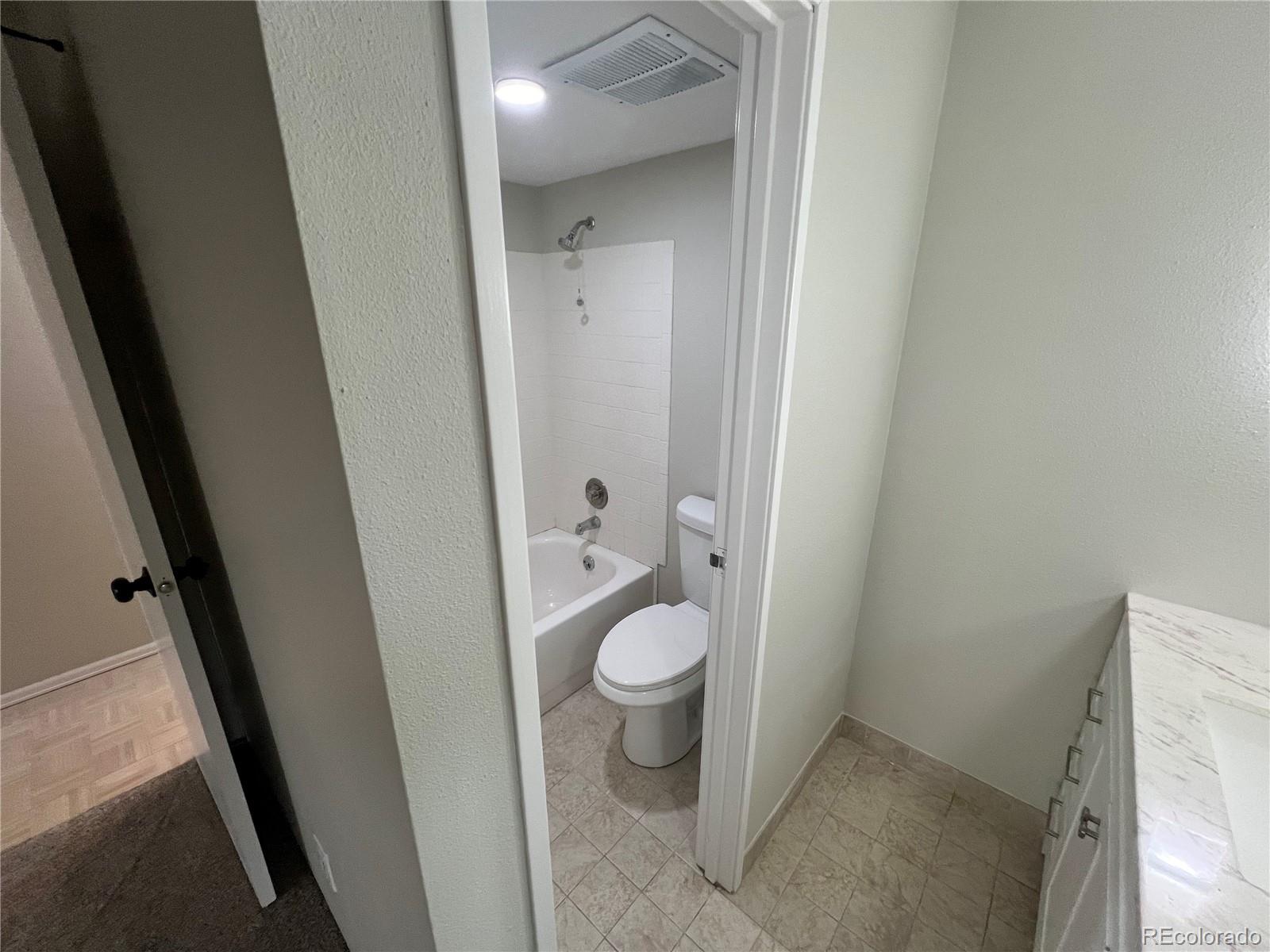 2880 South Locust Street, Unit 507S Denver, CO 80222 - Photo 38 of 48 a bathroom with a granite countertop toilet and a sink