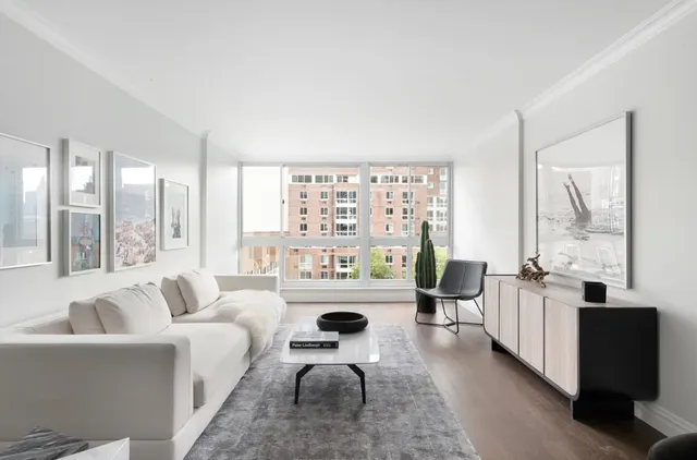 a living room with furniture and large windows