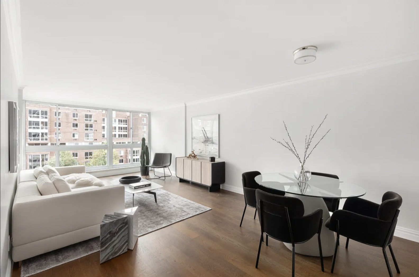 625 Main Street, Unit 1432 Manhattan, NY 10044 - Photo 2 of 12 a living room with furniture and a large window