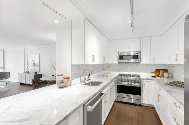 a kitchen that has a lot of cabinets in it and appliances
