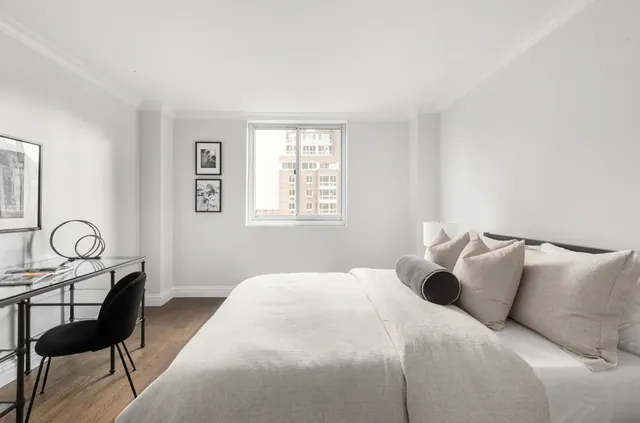 a bedroom with a bed and a chair