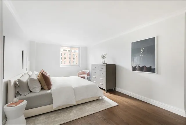 a bedroom with a bed and a couch