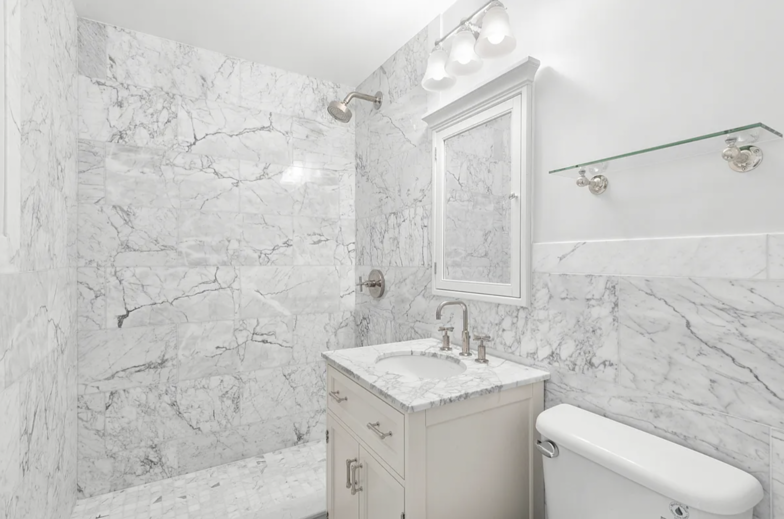 625 Main Street, Unit 1432 Manhattan, NY 10044 - Photo 8 of 12 a bathroom with a granite countertop sink toilet and shower
