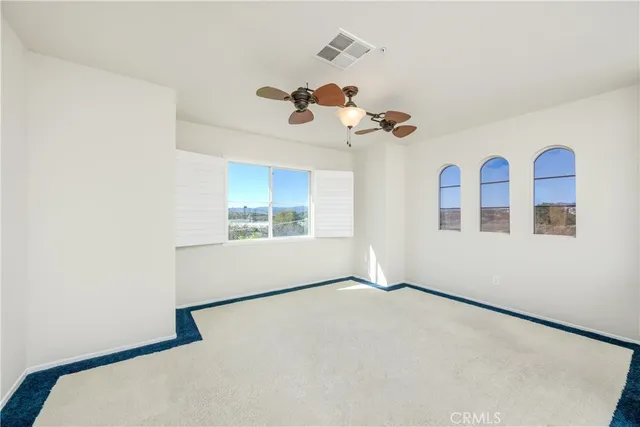 a view of staircase with railing and white walls