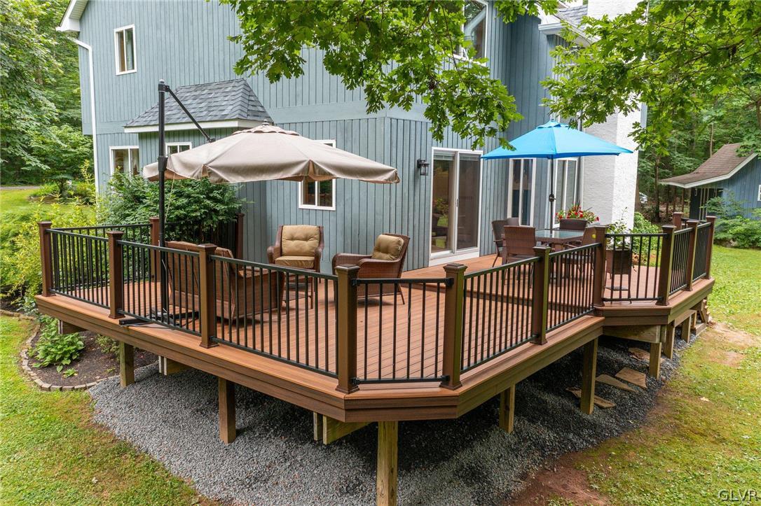 3220 Winding Road Kintnersville, PA 18930 - Photo 11 of 50 a view of a wooden deck with furniture and a yard