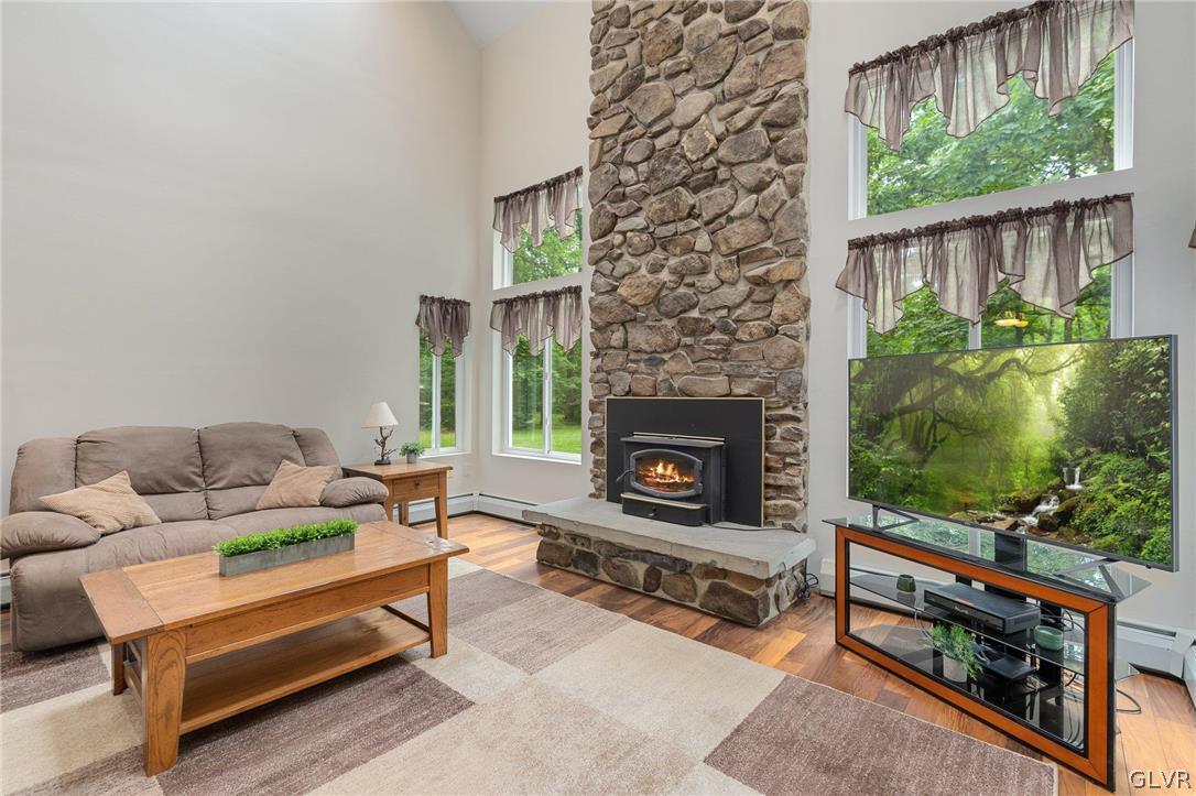 3220 Winding Road Kintnersville, PA 18930 - Photo 20 of 50 a living room with furniture a flat screen tv and a fireplace