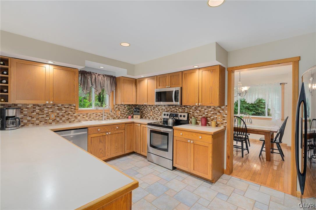3220 Winding Road Kintnersville, PA 18930 - Photo 27 of 50 a kitchen with a stove top oven sink and cabinets