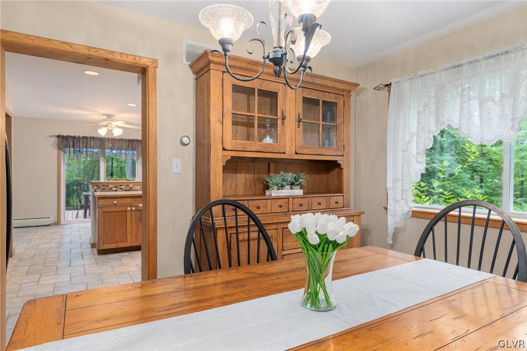 3220 Winding Road Kintnersville, PA 18930 - Photo 35 of 50 a view of a dining room with furniture a livingroom and chandelier