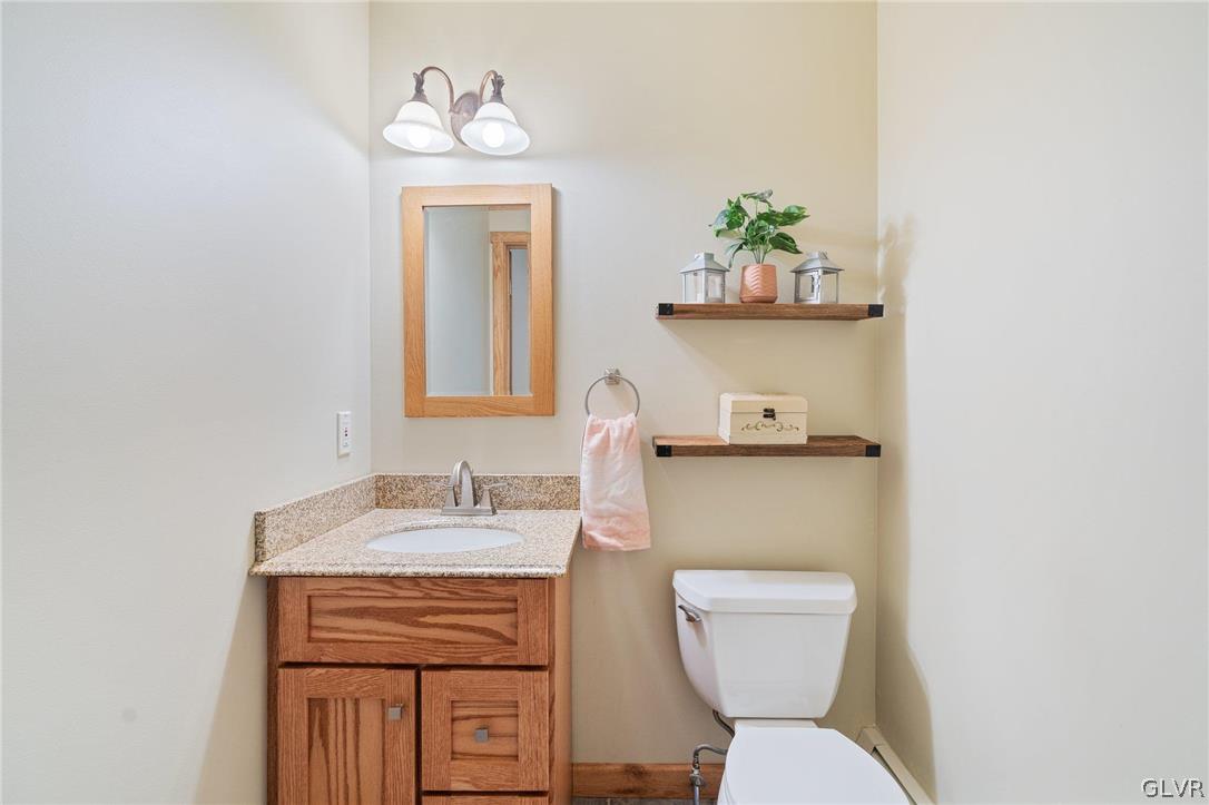 3220 Winding Road Kintnersville, PA 18930 - Photo 37 of 50 a bathroom with a toilet sink and mirror