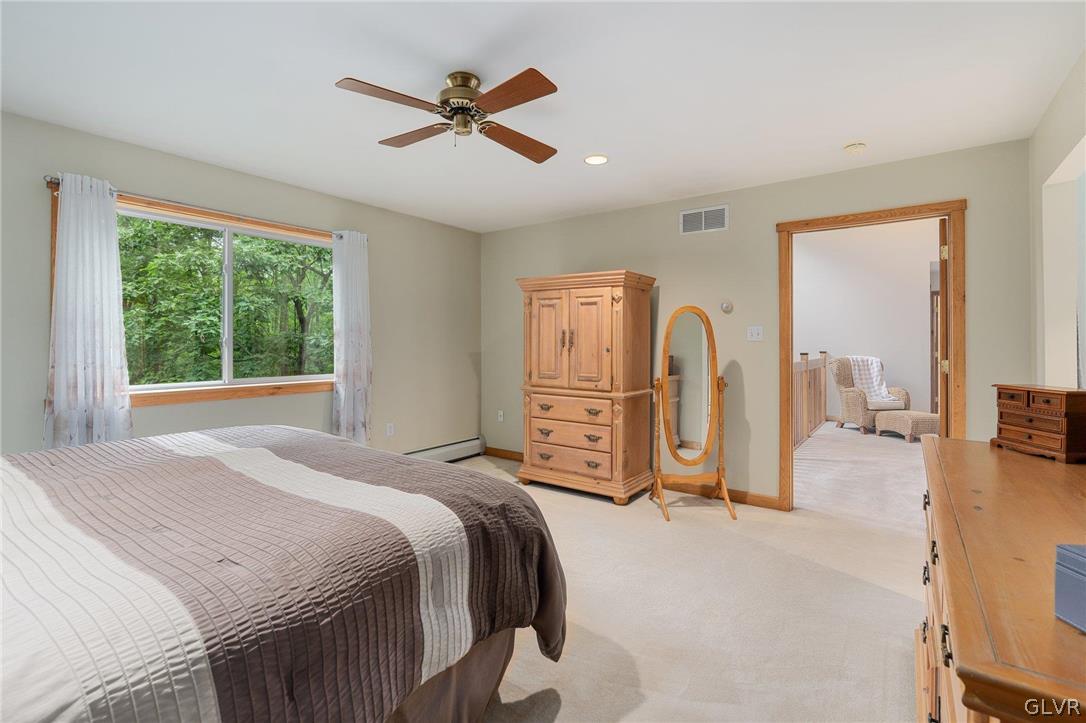 3220 Winding Road Kintnersville, PA 18930 - Photo 43 of 50 a bedroom with a bed a ceiling fan and a large window