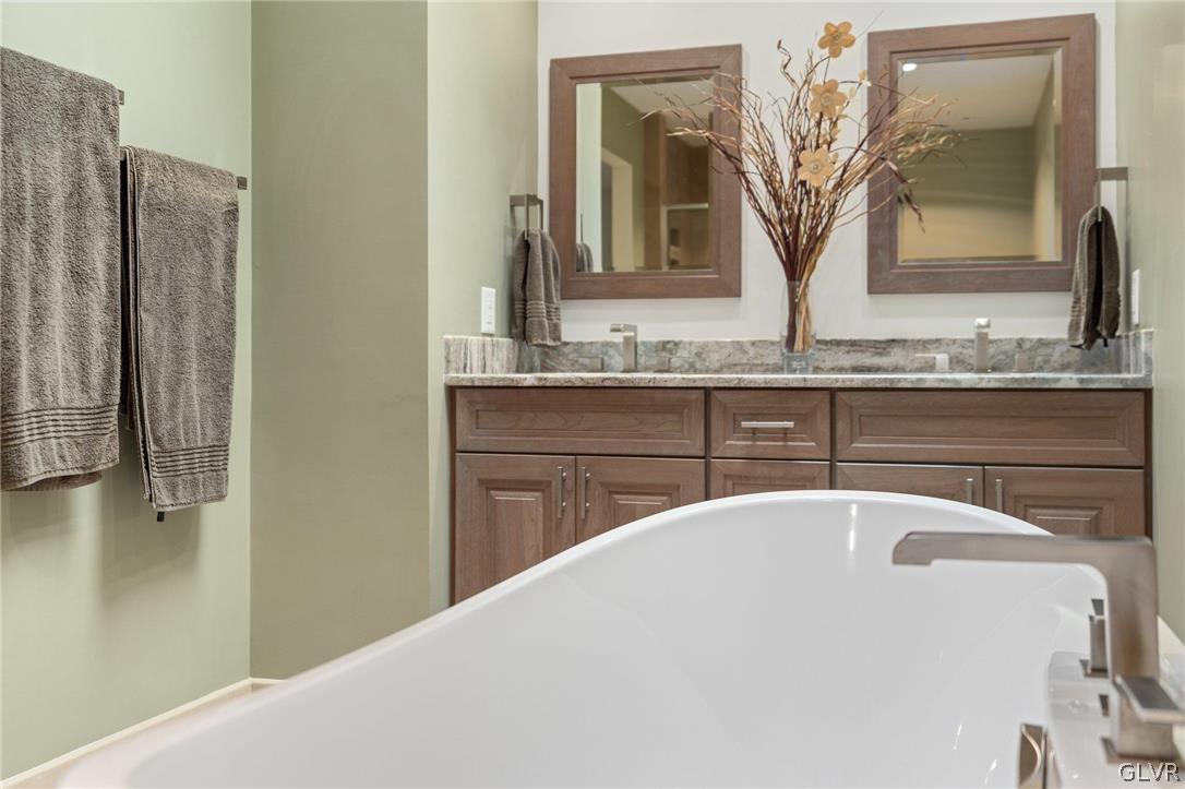 3220 Winding Road Kintnersville, PA 18930 - Photo 47 of 50 a bathroom with a granite countertop sink and a mirror