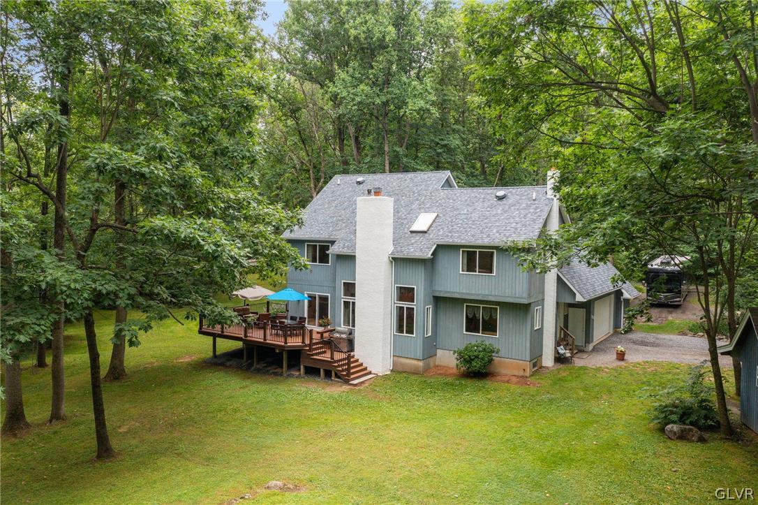 3220 Winding Road Kintnersville, PA 18930 - Photo 7 of 50 a view of a house with garden and a tree