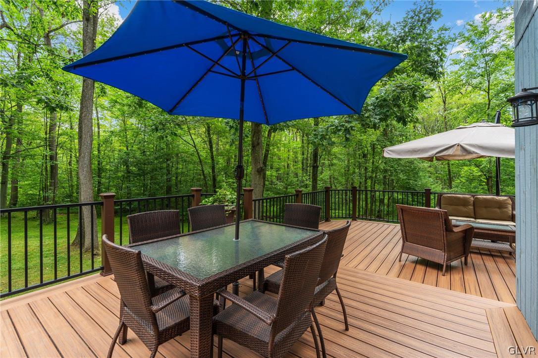 3220 Winding Road Kintnersville, PA 18930 - Photo 8 of 50 a patio with wooden floor a yard a table and chairs
