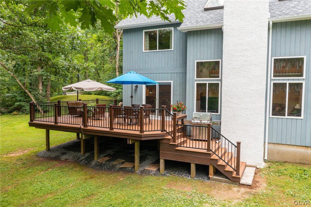 3220 Winding Road Kintnersville, PA 18930 - Photo 10 of 50 a view of a house with a wooden deck and furniture