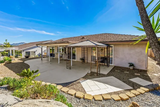 a view of a patio with table and chairs and potted plants